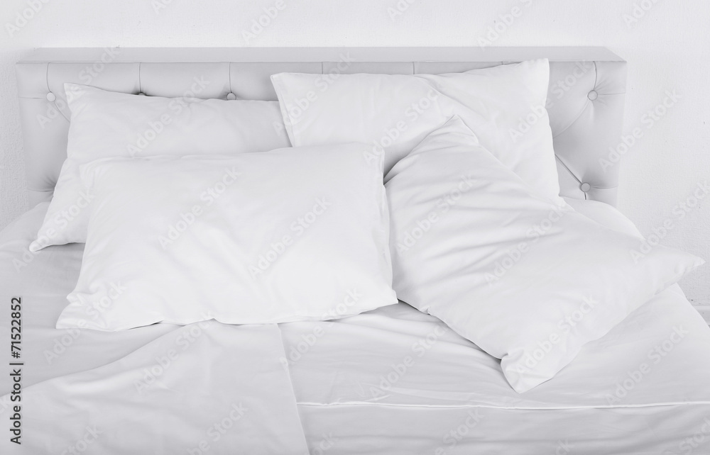 White pillows on bed in room White pillows on bed in room