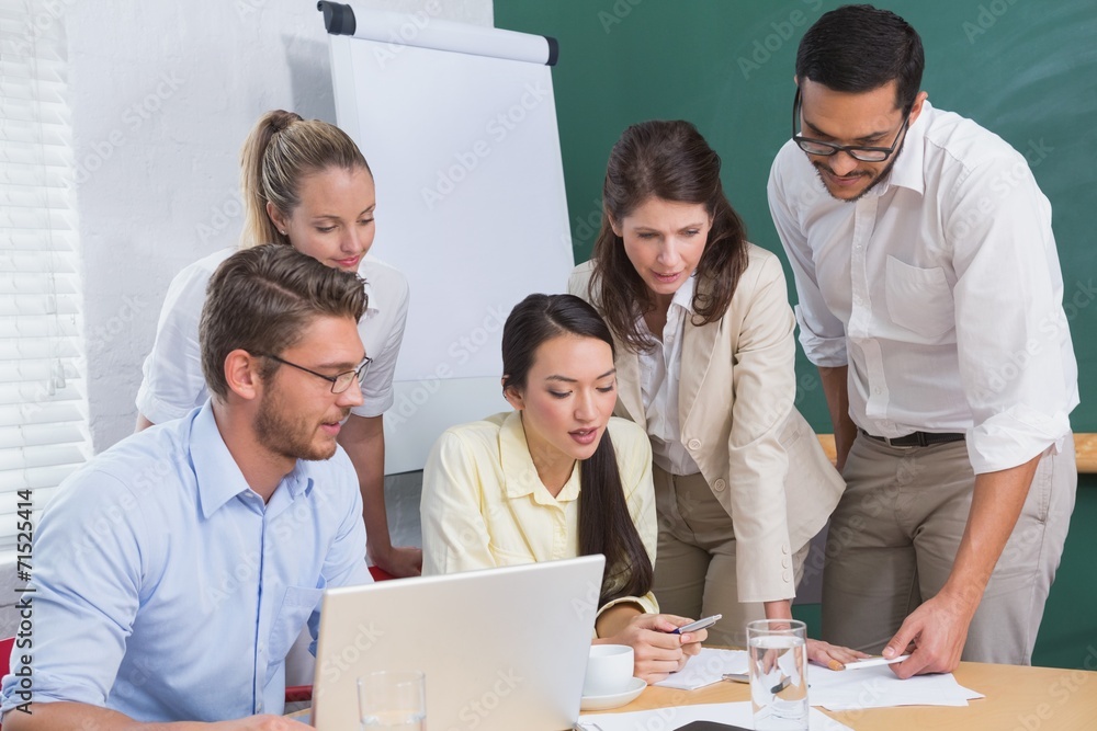 Casual business team having a meeting using laptop Casual business team having a meeting using laptop