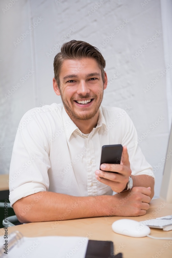 Businessman using mobile phone in office Businessman using mobile phone in office