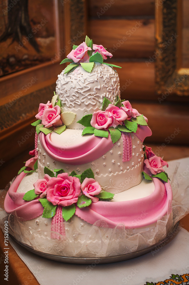 Pink and white wedding cake on a dessert table Pink and white wedding cake on a dessert table
