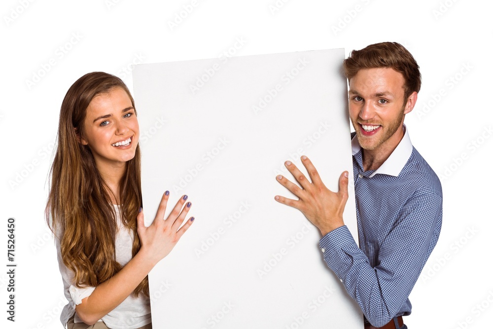 Happy young couple with blank board