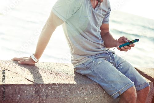 mobile smartphone in man's hands near the sea