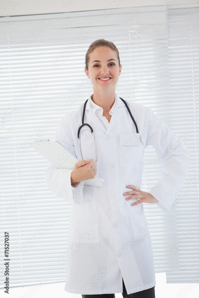 Happy doctor holding a clipboard Happy doctor holding a clipboard