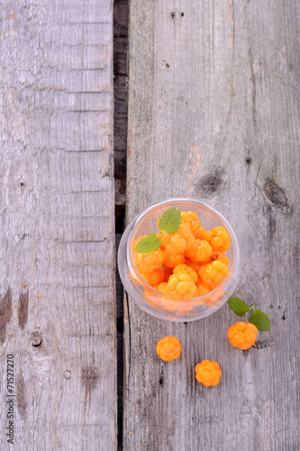 organic fresh northern cloudberries on a wooden background