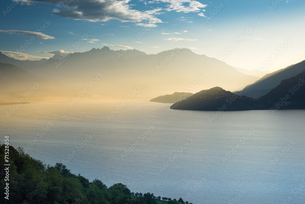 First sunrays over Lake Como looking from Italy into Switzerland
