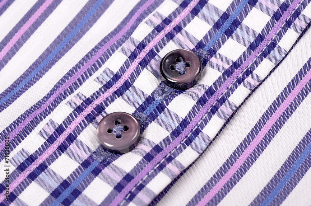 Close-up of buttons on a striped purple shirt Close-up of buttons on a striped purple shirt