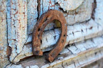 Old horse shoe on vintage wooden door, outdoors