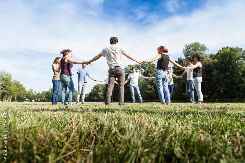 Group of friends at the park holding hands. Group of friends at the park holding hands.