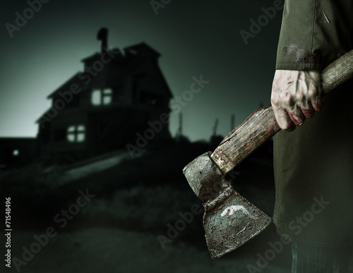 Axe with blood in male hand.