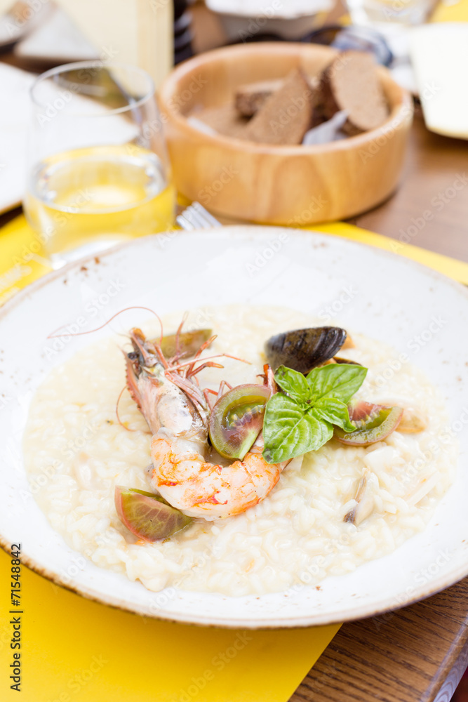 Seafood risotto with shrimp, tomatoes and basil Seafood risotto with shrimp, tomatoes and basil