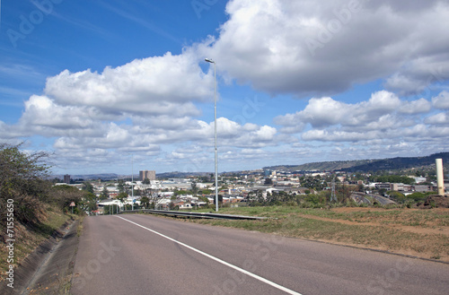 Empty Tarmac Road with View of Industrial Area