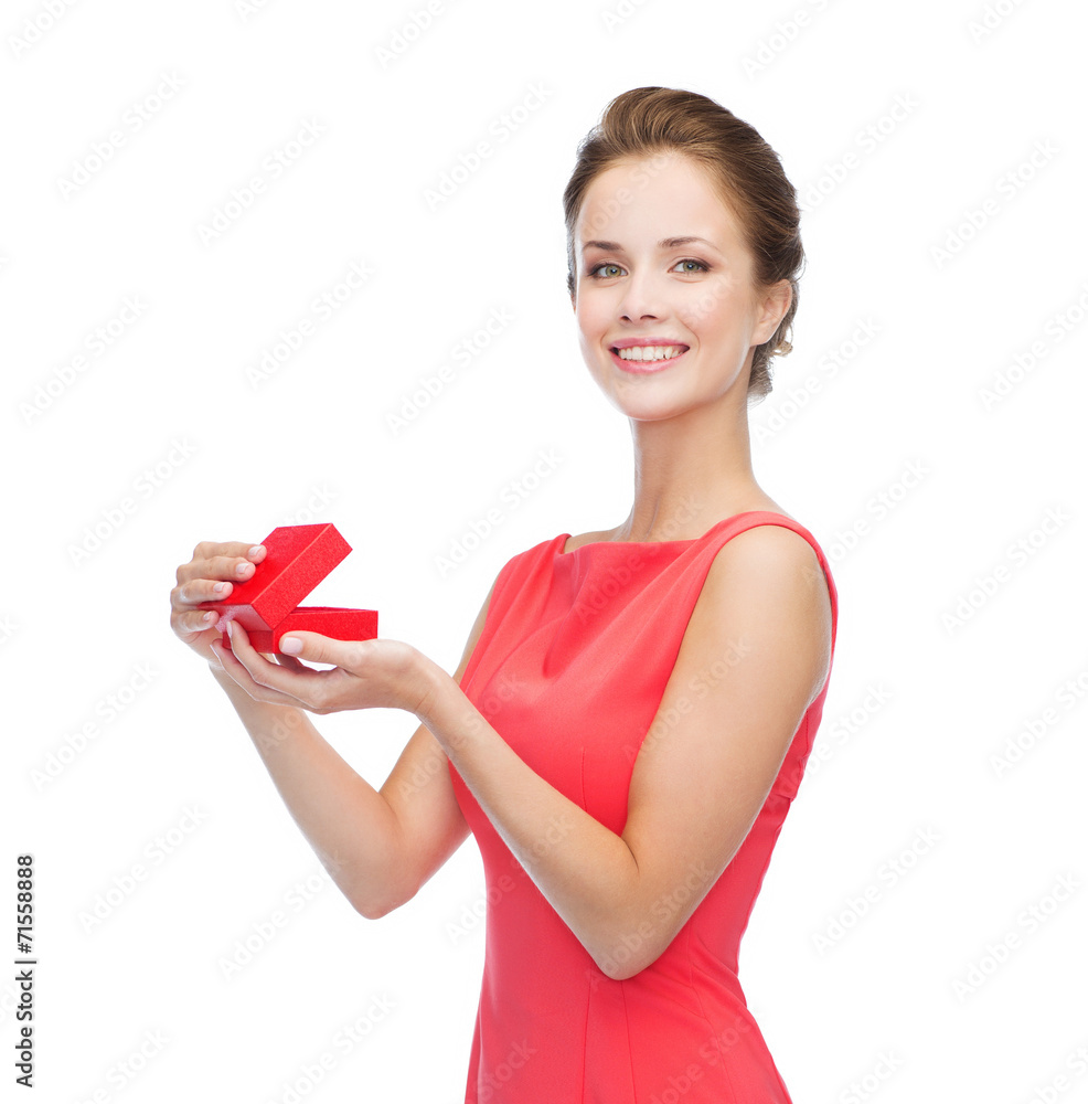 smiling young woman in red dress with gift box smiling young woman in red dress with gift box