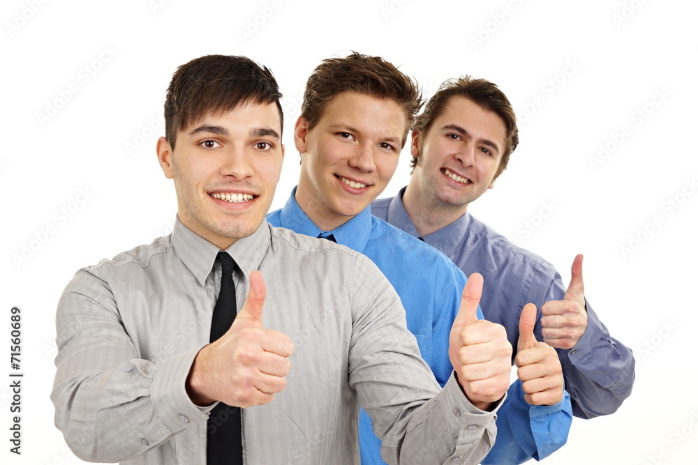 Three business young people shows you thumbs up Three business young people shows you thumbs up