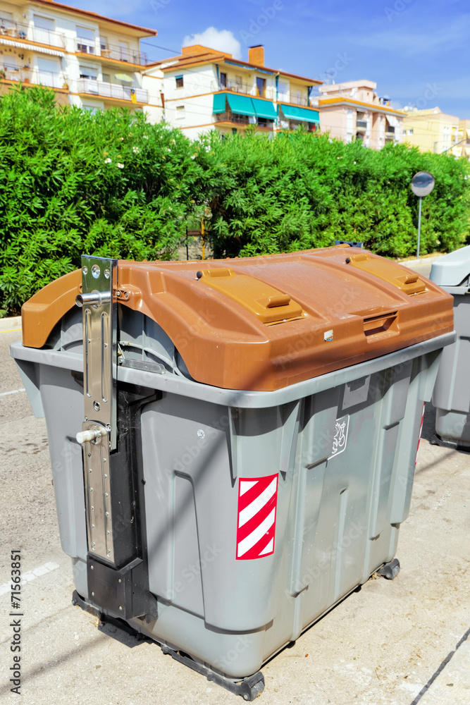 Variety dumpsters(recycling containers ) on a city street. Variety dumpsters(recycling containers ) on a city street.