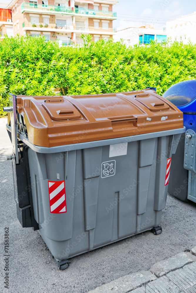Variety dumpsters(recycling containers ) on a city street. Variety dumpsters(recycling containers ) on a city street.