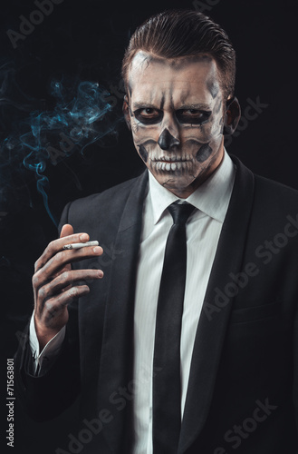portrait businessman smoking with makeup skeleton