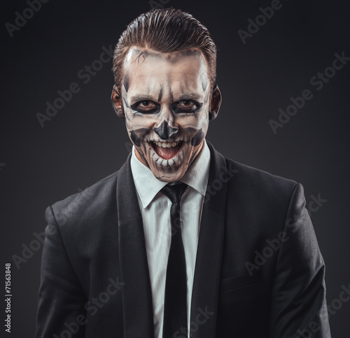 cunning businessman with a makeup of the skeleton