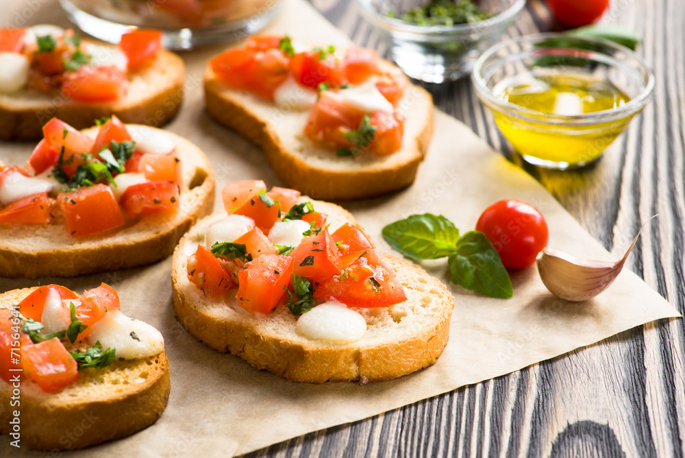 Bruschetta with roasted tomatoes, mozzarella cheese, garlic and Bruschetta with roasted tomatoes, mozzarella cheese, garlic and