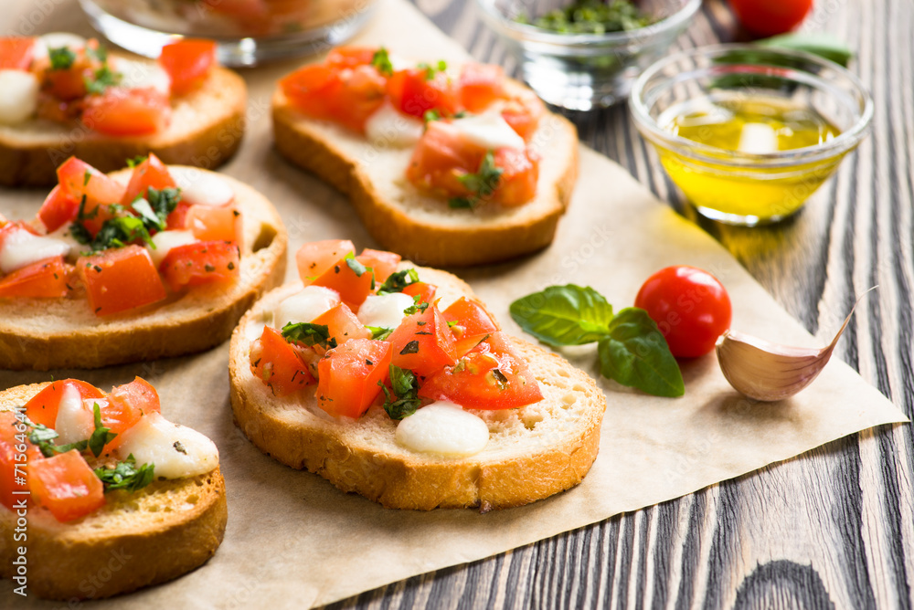 Bruschetta with roasted tomatoes, mozzarella cheese, garlic and