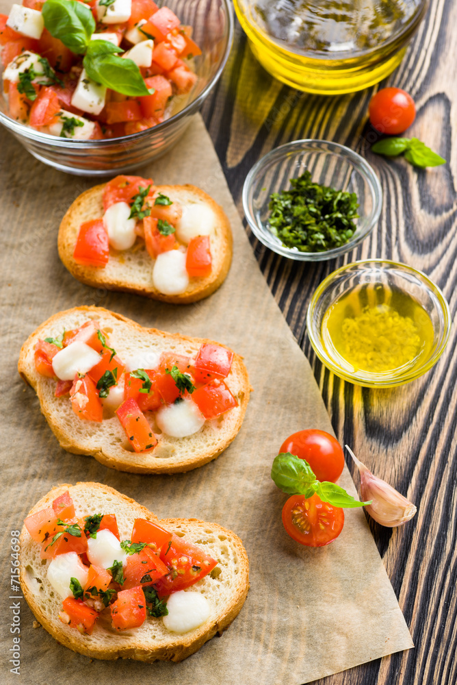 Bruschetta with roasted tomatoes, mozzarella cheese, garlic and Bruschetta with roasted tomatoes, mozzarella cheese, garlic and