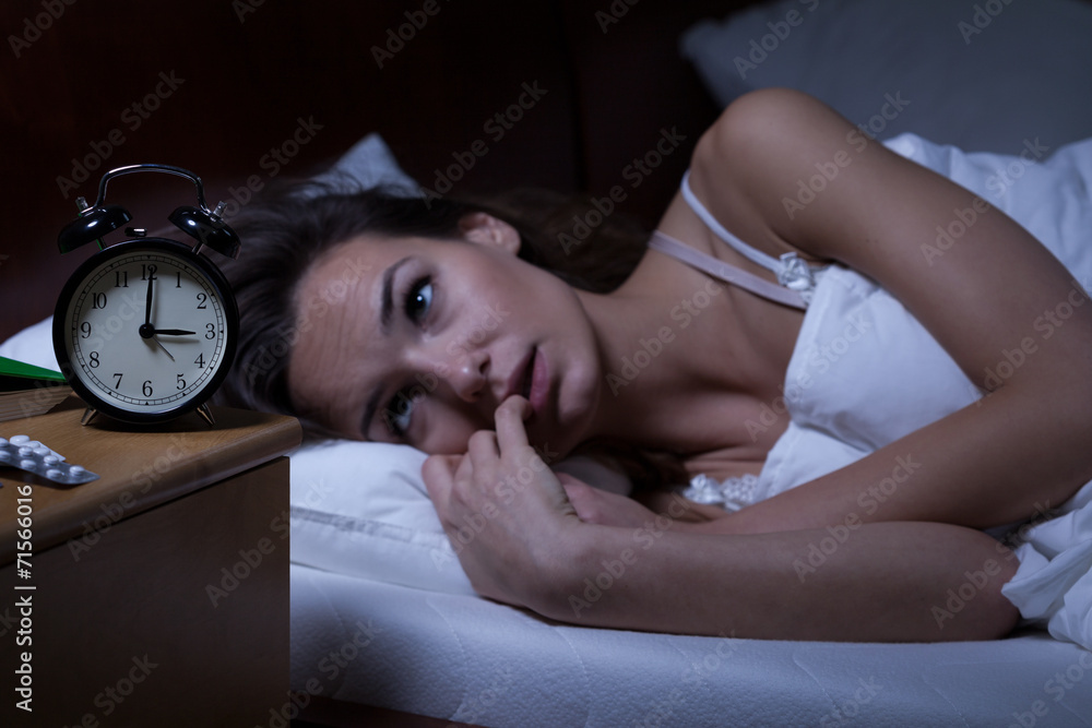 Woman lying in bed sleepless - obrazy, fototapety, plakaty 