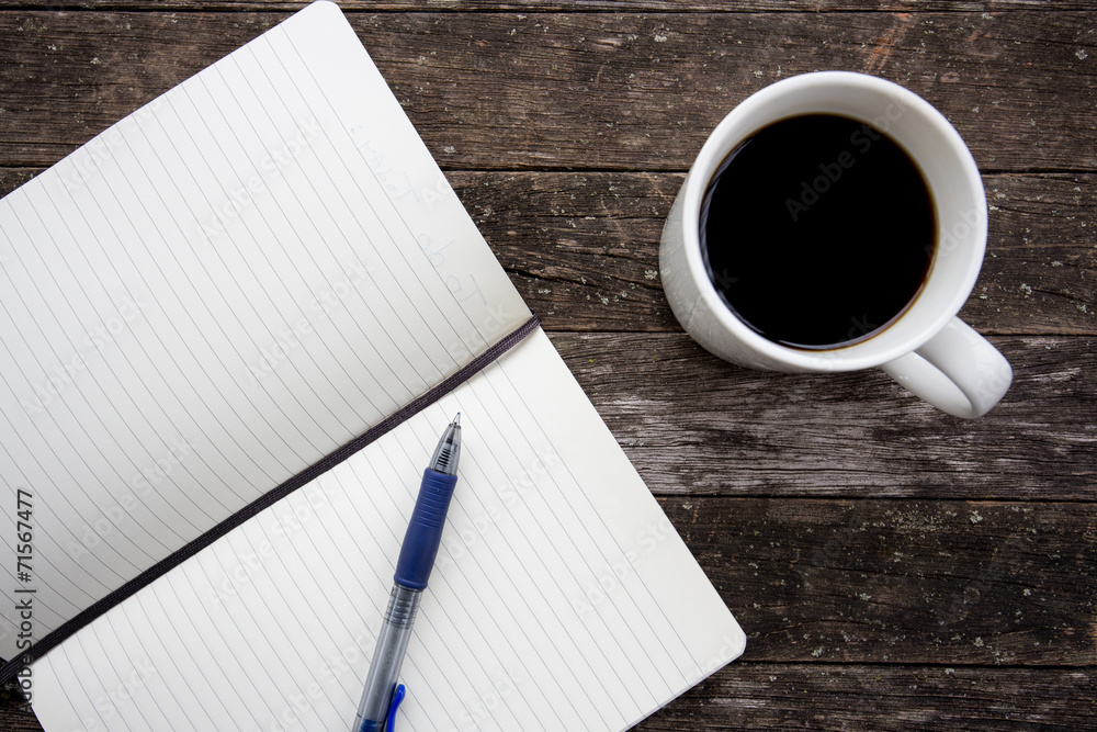 image of coffee cup with notebook and pen on an old wooden table image of coffee cup with notebook and pen on an old wooden table