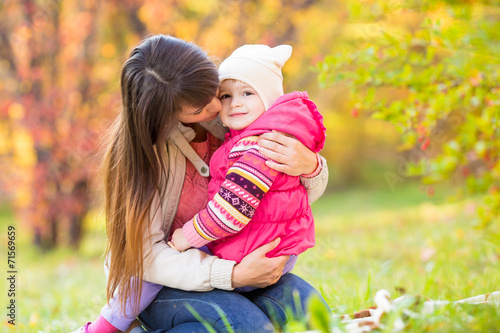 beautiful mother embracing ...