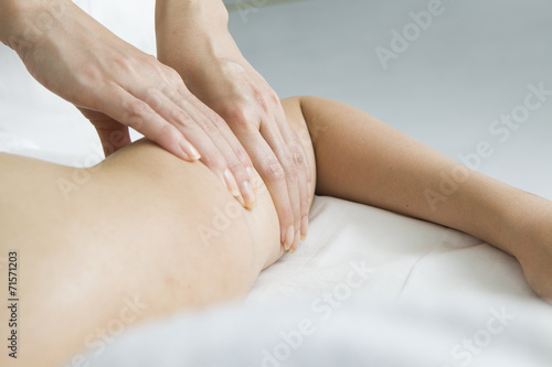 Young women undergoing massage of upper arm