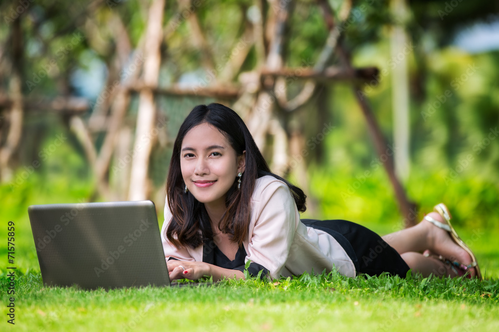 Young pretty asia woman with laptop typing Young pretty asia woman with laptop typing