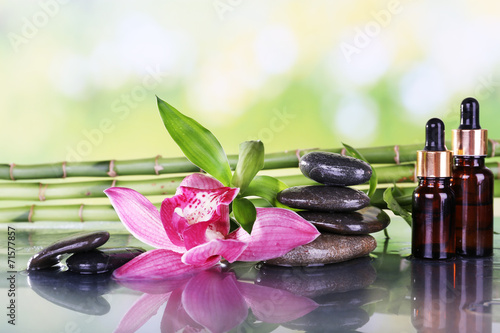 Fototapeta Naklejka Na Ścianę i Meble -  Spa stones, orchid, bamboo branches and aroma oil
