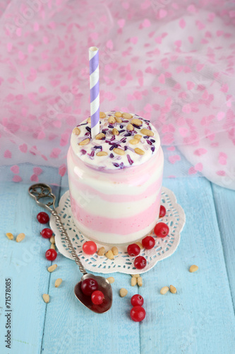 Cranberry milk dessert in glass jar,