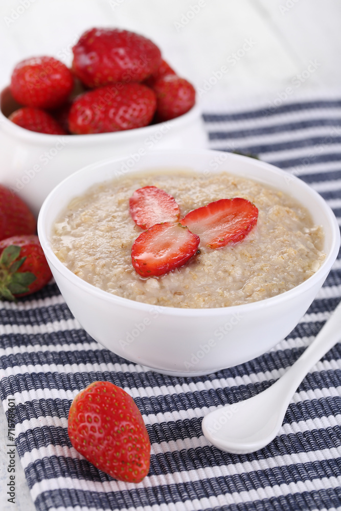 Tasty oatmeal with strawberry on table close-up Tasty oatmeal with strawberry on table close-up