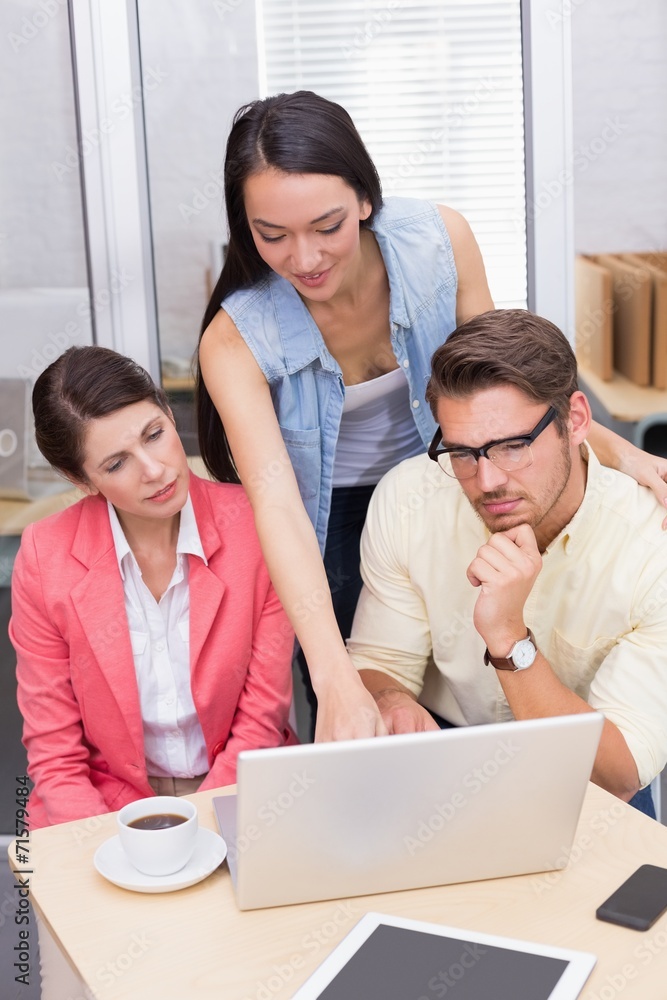 Business team using laptop and having coffee Business team using laptop and having coffee