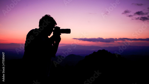 Man take a photograph during sunset