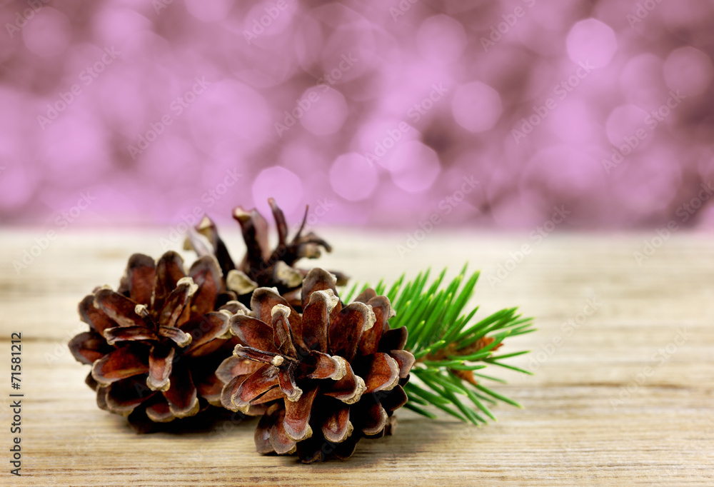 pine cones on a wooden board against christmas bokeh background pine cones on a wooden board against christmas bokeh background