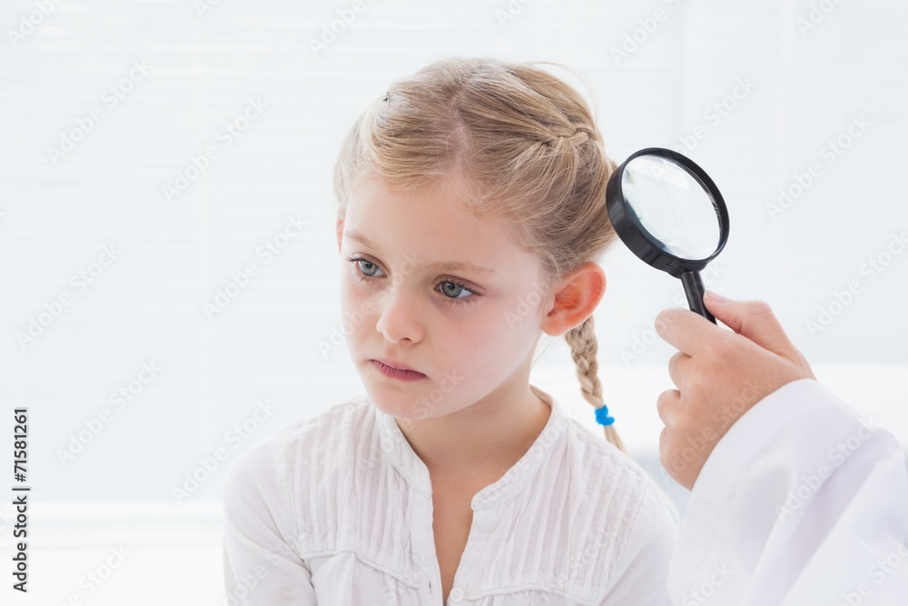 Doctor examining patient with magnifying glass Doctor examining patient with magnifying glass