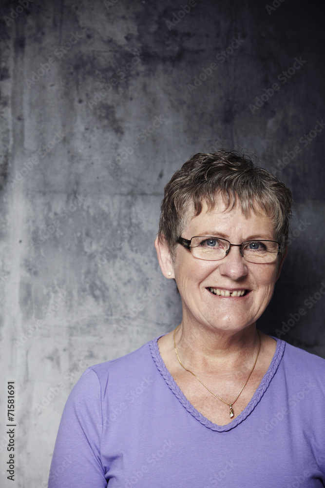 Portrait of smiling senior woman in purple top Portrait of smiling senior woman in purple top