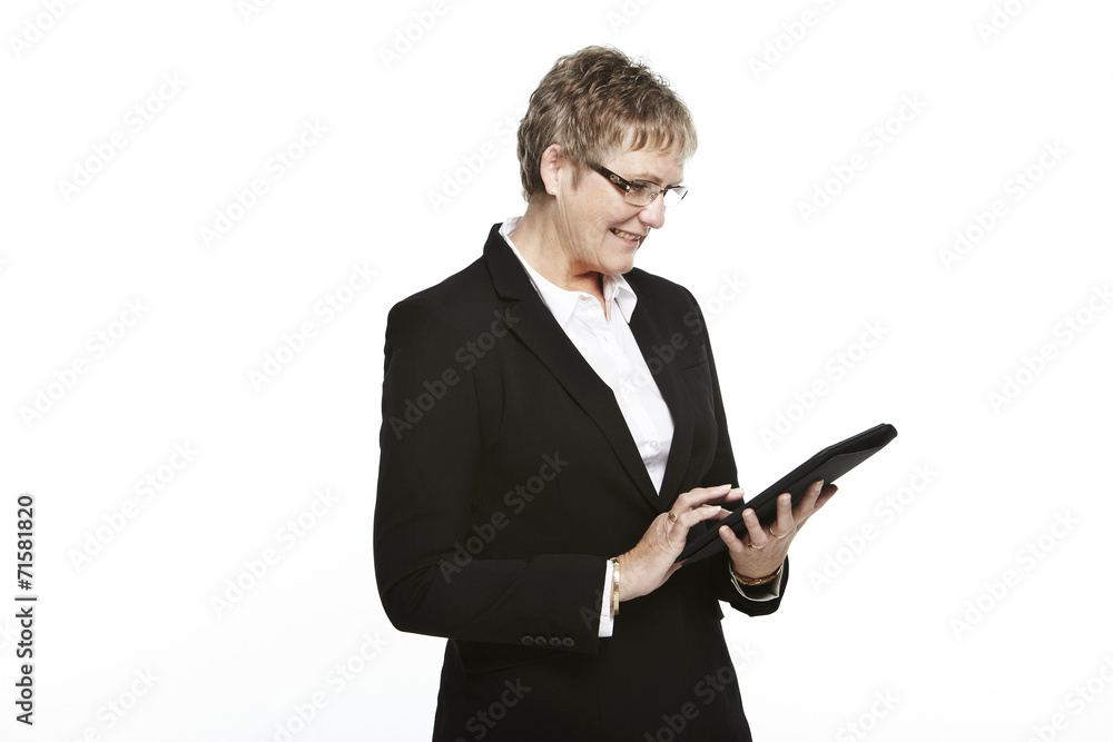 Senior businesswoman using tablet, studio Senior businesswoman using tablet, studio