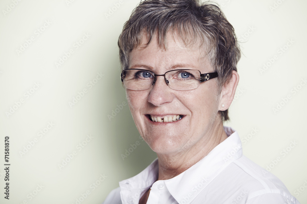 Portrait of senior woman smiling, studio