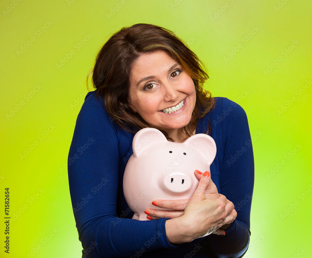 woman holding piggy bank isolated on green background woman holding piggy bank isolated on green background
