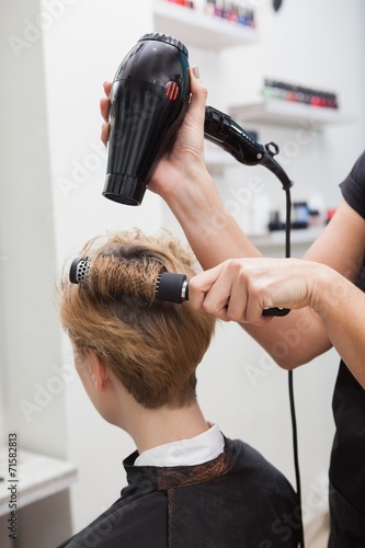 Hairdresser drying a customers hair