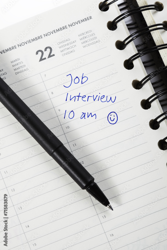 Pen and diary entry for job interview, close up Pen and diary entry for job interview, close up
