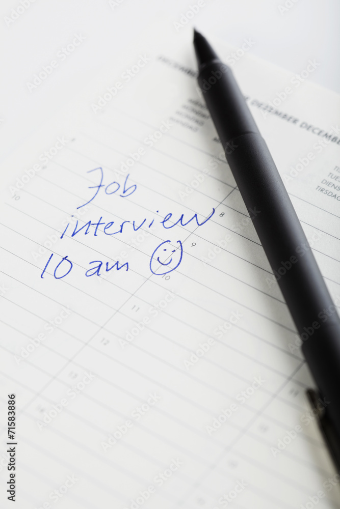 Pen and diary entry for job interview, close up Pen and diary entry for job interview, close up