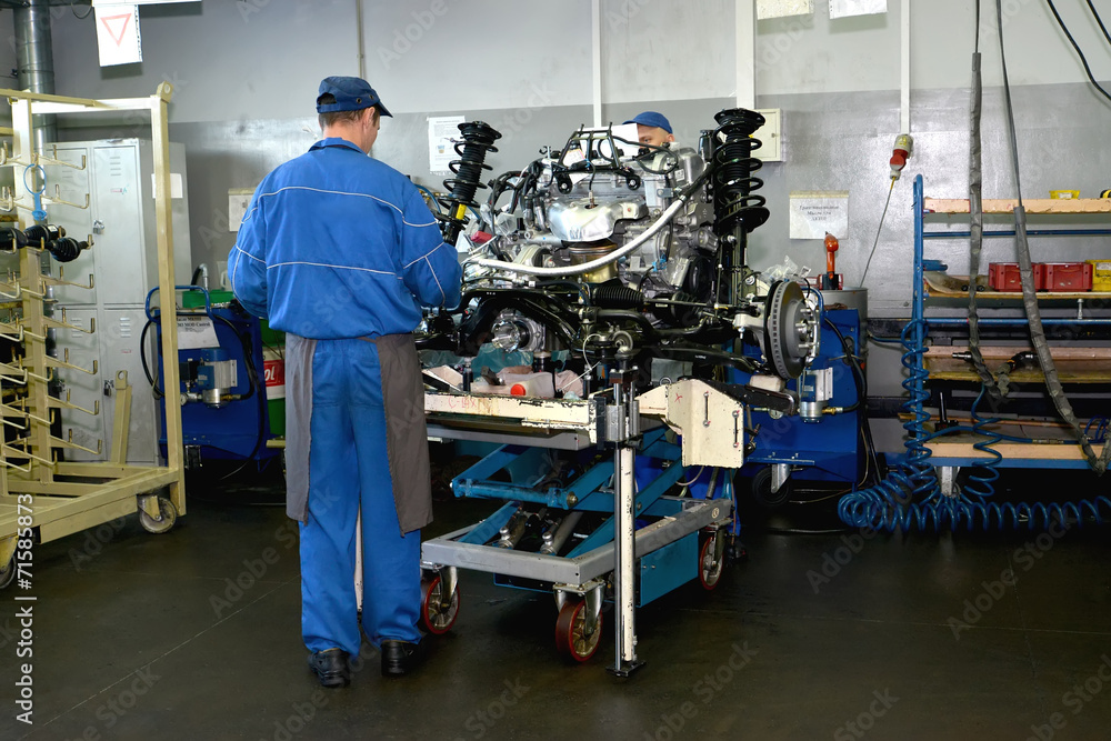 Work on a site of subassembly of automobile engines. Assembly sh Work on a site of subassembly of automobile engines. Assembly sh