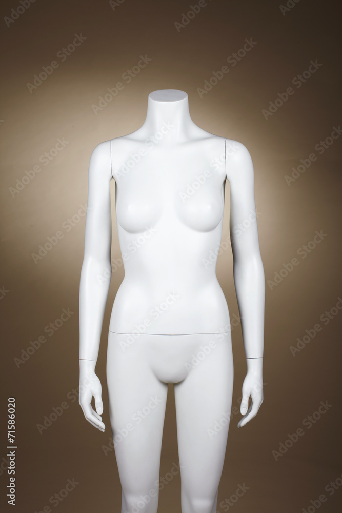 Incomplete female mannequin against brown background Incomplete female mannequin against brown background