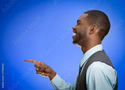 side profile man laughing pointing with finger at someone photo