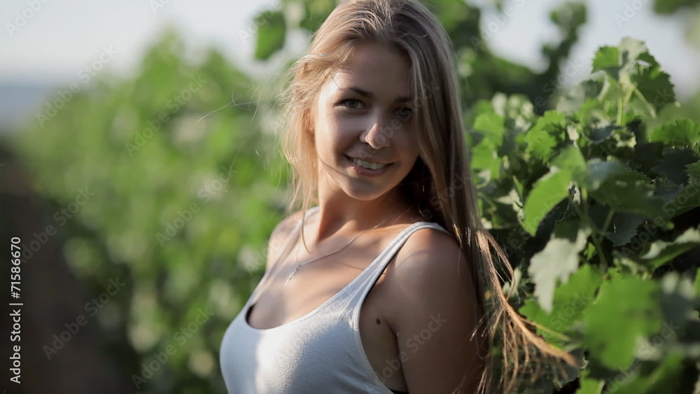 Pretty girl posing and smiling in the middle of vineyards Pretty girl posing and smiling in the middle of vineyards