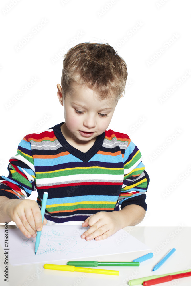 Creative boy drawing with pens on paper, studio Creative boy drawing with pens on paper, studio