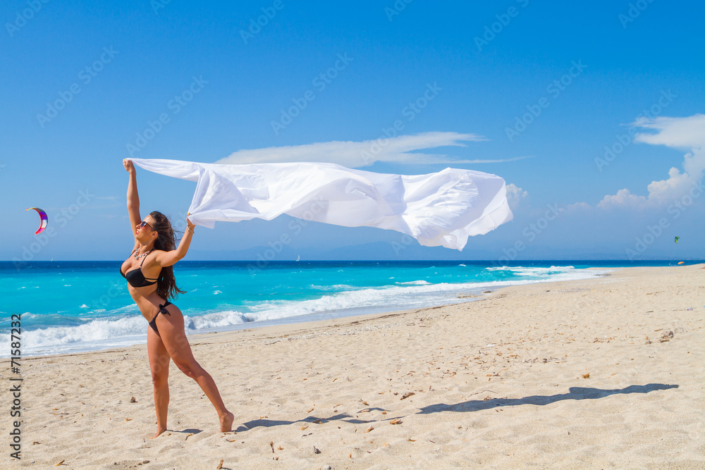 Beautiful Girl With White fabric on The Beach.