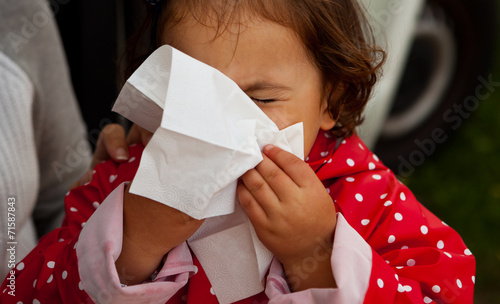 Fotografia Baby girl blowing  for herself nose